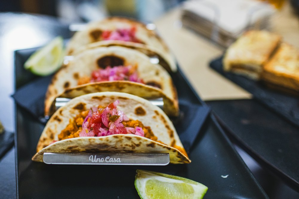 Stock photo of tacos with pickled onions and lime